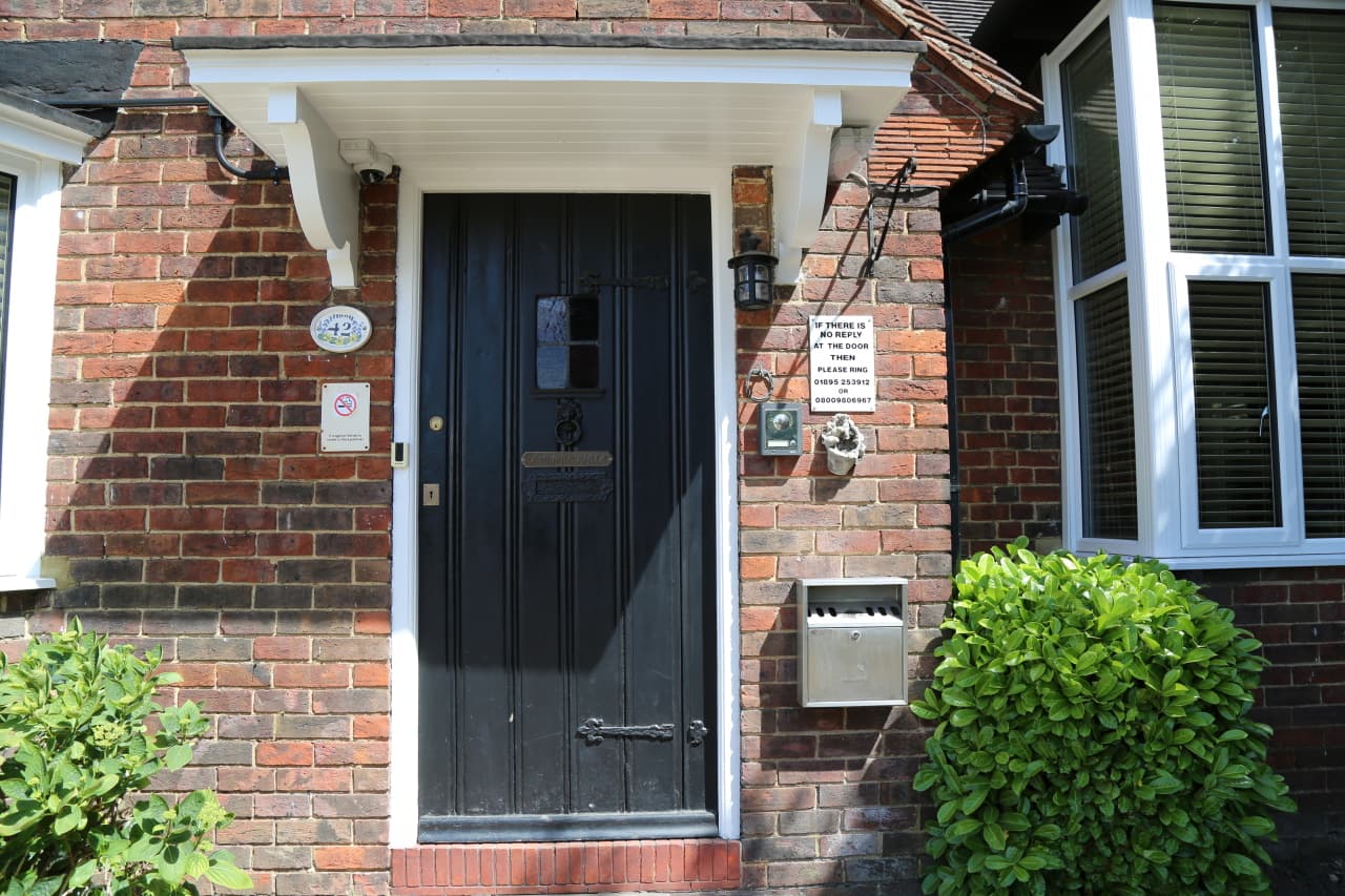 The black front door and porch of Debden Guest House