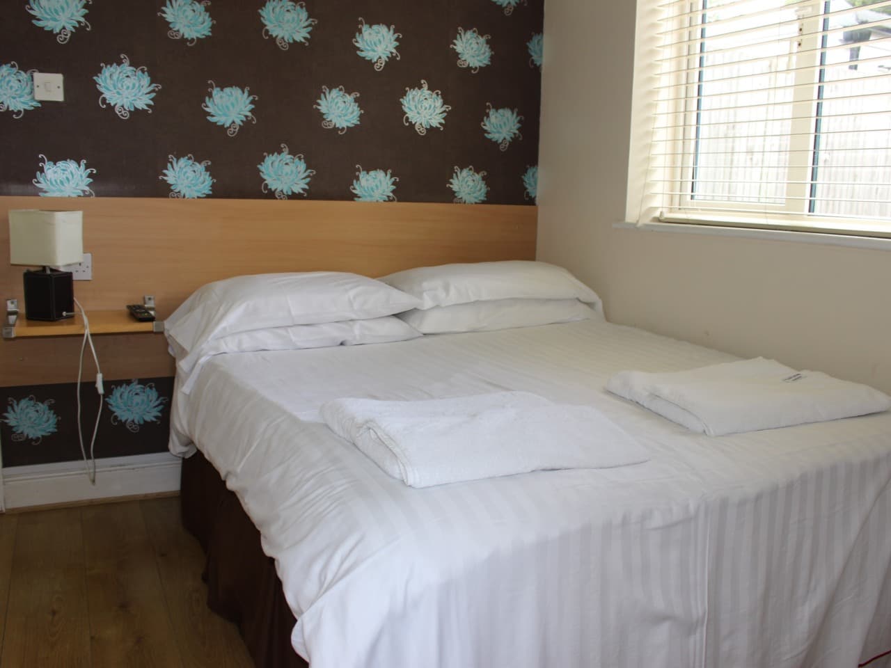 Double room with a patterned feature wall and a large window