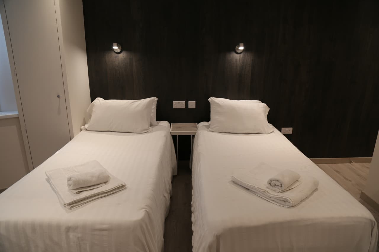 Twin room with two single beds and reading lights
