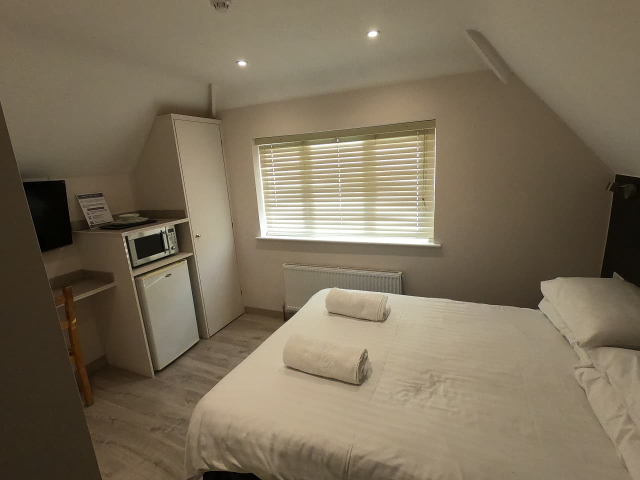 Loft-style double room with sloping ceiling and Velux windows