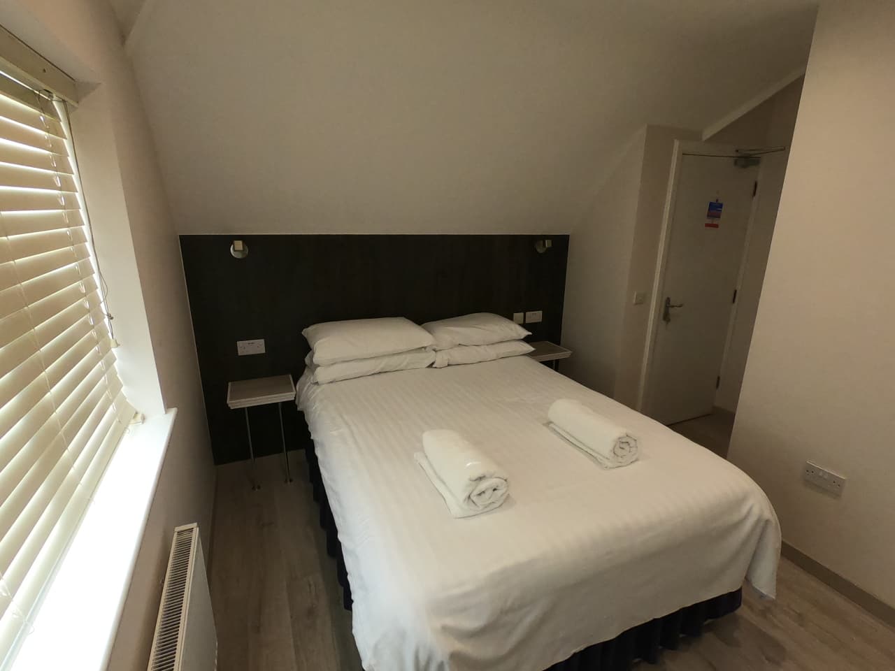 Loft-style room with a double bed and a fitted wardrobe