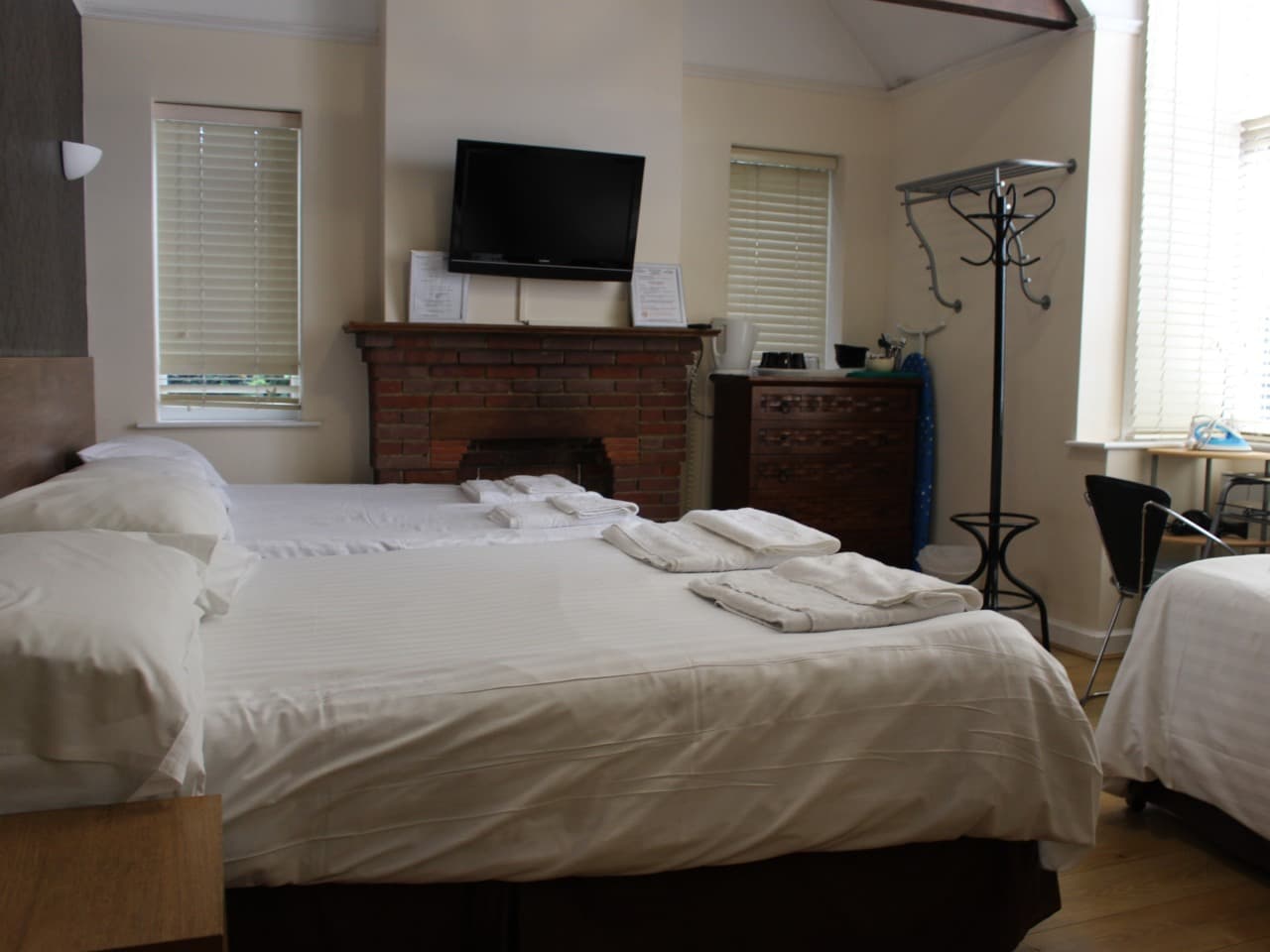 Large family room with a feature fireplace and two beds