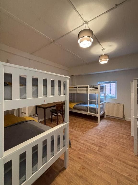Dormitory bunk beds beside a window