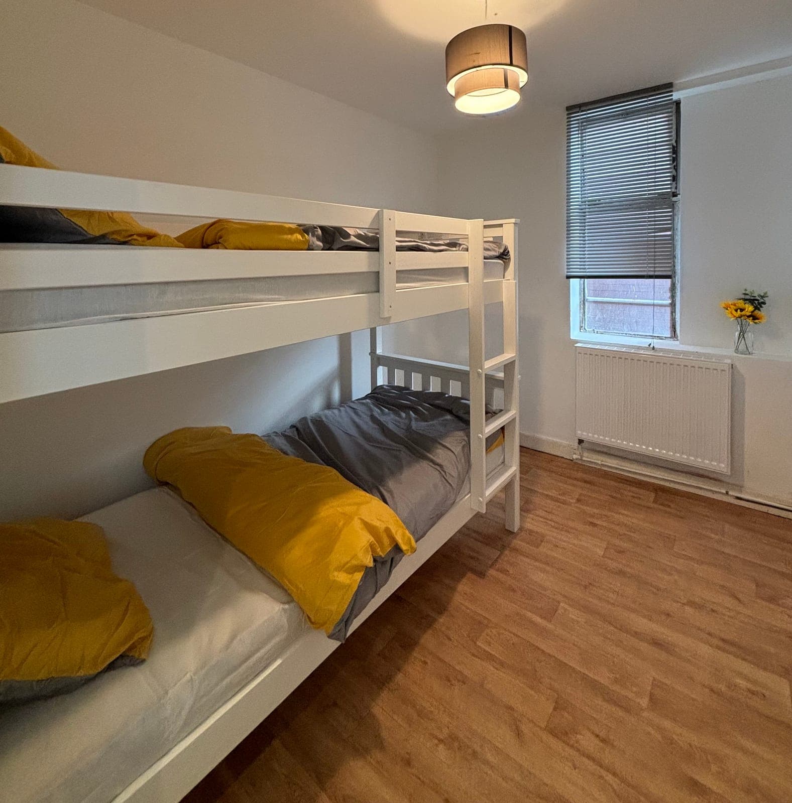 Twin room with bunk beds and yellow pillows
